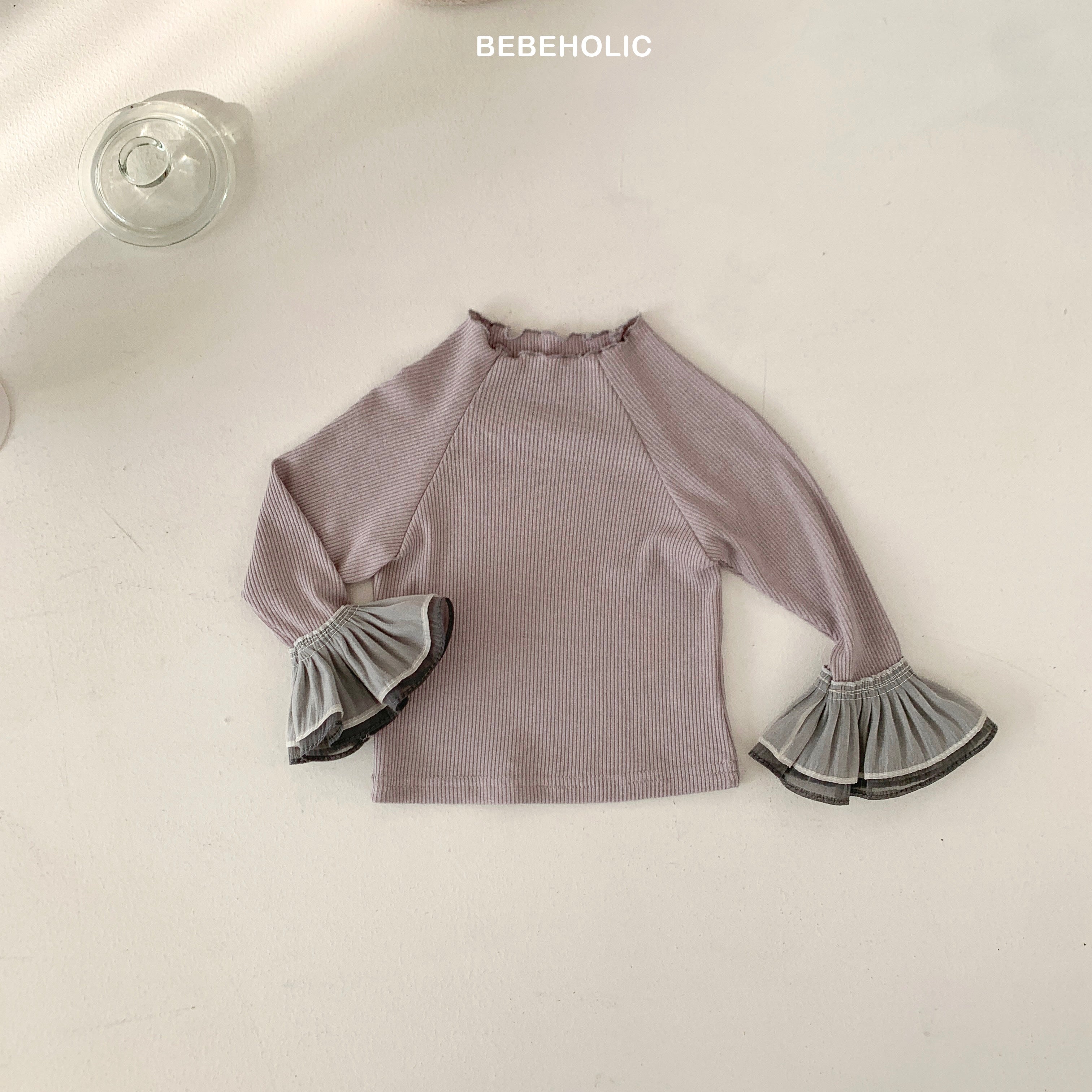 Stylish Double Frill Tee from Bebeholic features soft ribbed fabric and elegant ruffles for baby comfort.