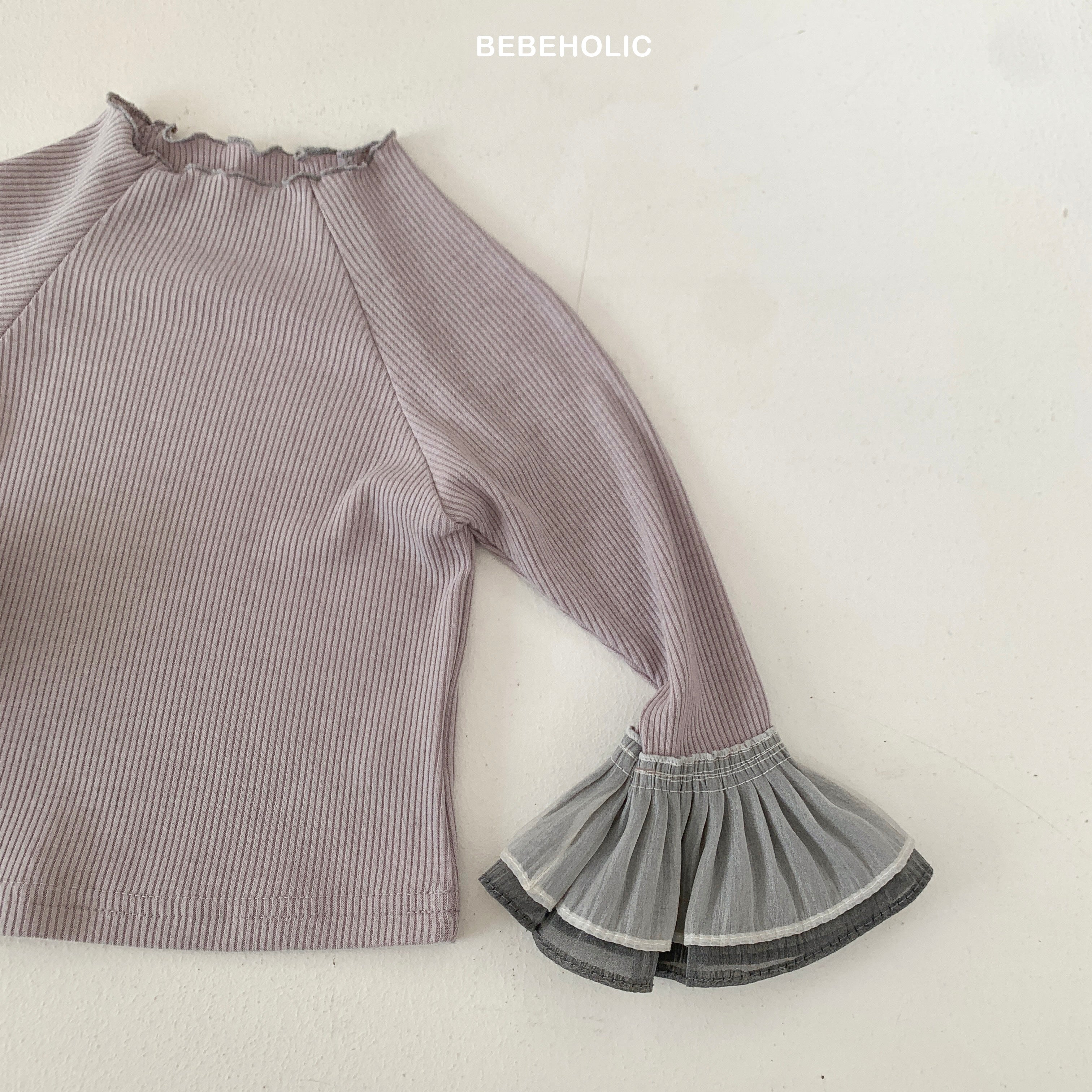 Stylish Double Frill Tee from Bebeholic features soft cotton blend and elegant frill details for baby comfort.
